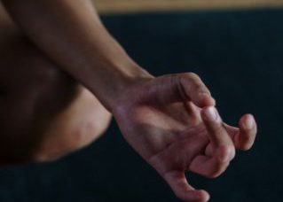 "Close-up of a person holding their feet with pink nail polish, showcasing a self-care and relaxation moment